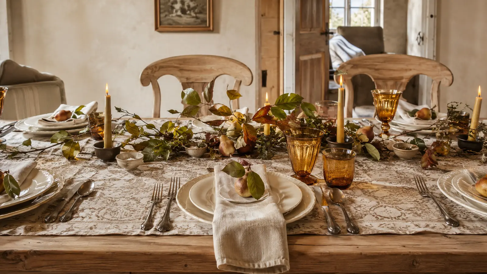 A close-up of varied glassware shapes in the same warm tone at a place setting